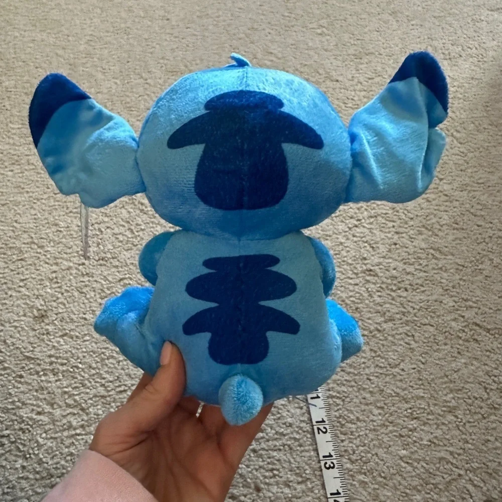 Stitch holding a coffee